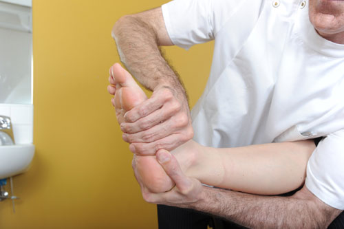 Therapist helping someone with their foot health care